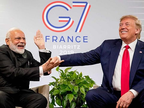 Indian Prime Minister Narendra Modi, left, slaps the hand of President Donald Trump as they share a laugh during a bilateral meeting at the G-7 summit in Biarritz, France, Monday, Aug. 26, 2019.