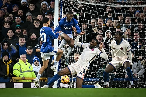 Everton's Senegalese striker Iliman Ndiaye, Portuguese striker Beto fight for possession with Chelsea's English defender Tosin Adarabioyo during the English Premier League football match at Goodison Park in Liverpool on December 22.