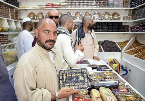 Pilgrims shop for gifts at Medina stores before departure from Saudi Arabia.
