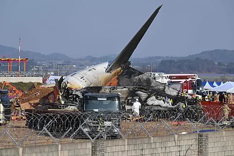 Firefighters and rescue personnel work near the wreckage of a Jeju Air Boeing 737-800 series aircraft after the plane crashed and burst into flames at Muan International Airport in South Jeolla Province.