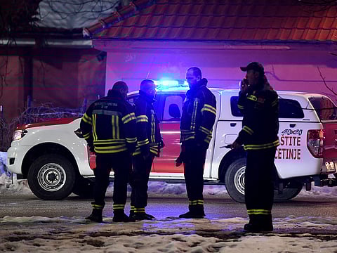 Police officers and civil protection units secure a crime scene after a gunman killed 10 people in the village of Bajice near Cetinje, Montenegro, on January 1, 2025.