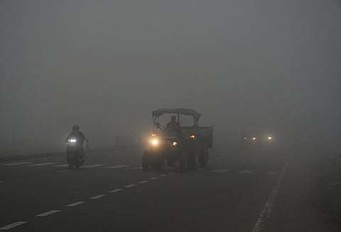Vehicles ply on roads amid the fog on a cold winter day, in Kanpur.