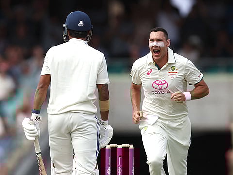 Australia’s Scott Boland (R) celebrates after dismissing India’s Nitish Kumar Reddy during day one of the fifth Test at the Sydney Cricket Ground on January 3, 2025.