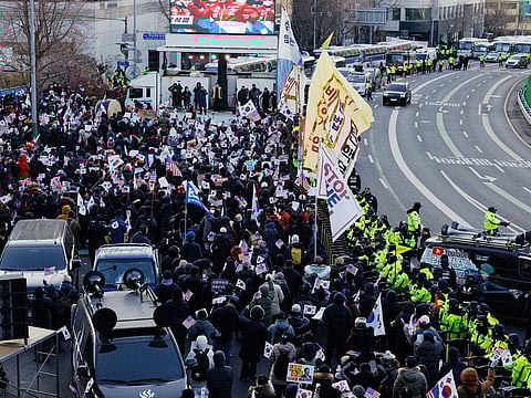 Police officers stand guard as supporters of South Korean President Yoon Suk Yeol gather near the presidential residence in Seoul, South Korea, on Friday, January 3, 2025.