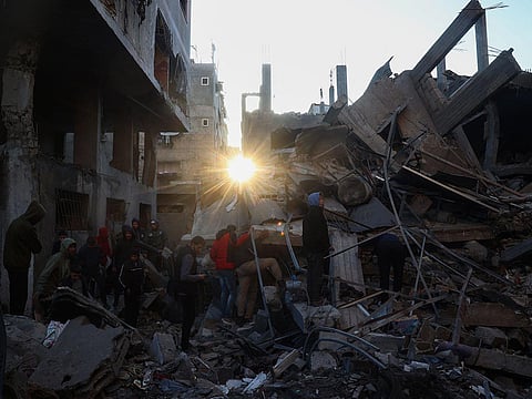 People search the rubble of a building destroyed in an Israeli strike on the Bureij camp for Palestinian refugees in the central Gaza Strip on January 8, 2025 as the war between Israel and the Palestinian Hamas movement continues.
