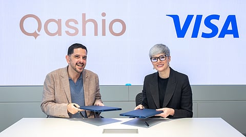 Armin Moradi (left), CEO and Co-founder of Qashio, and Salima Gutieva, Visa’s VP and Country Manager for the UAE, sign the partnership agreement