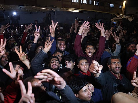 People celebrate along a street in Khan Yunis in the southern Gaza Strip on January 15, 2025. Thousands of Gazans celebrated as news spread that a ceasefire and hostage release deal had been reached between Israel and Hamas, aimed at ending more than 15 months of war in the Palestinian territory.