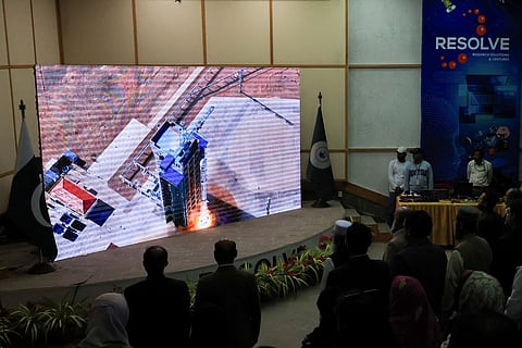 People watch a screen displaying the launch of Pakistan's indigenous Electro-Optical (EO-1) satellite from the Jiuquan Satellite Launch Centre (JSLC) in northern China, at the Pakistan Space and Upper Atmosphere Research Commission (SUPARCO) Complex in Karachi, Pakistan January 17, 2025.
