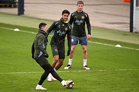 Manchester City's English midfielder Phil Foden (L) Brazilian defender Vitor Reis (C) and English midfielder Jacob Wright take part in a training session at Manchester City's training ground in Manchester, north-west England, on Tuesday.