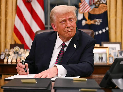 US President Donald Trump signs executive orders in the Oval Office of the White House in Washington, DC, on January 20, 2025.