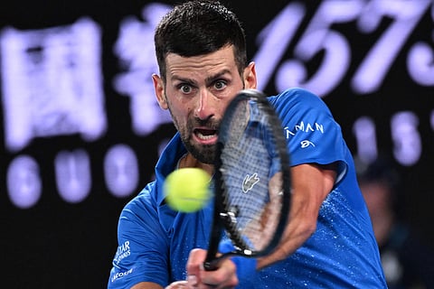 Serbia's Novak Djokovic hits a return against Spain's Carlos Alcaraz during their men's singles quarterfinal match on day ten of the Australian Open tennis tournament in Melbourne on Tuesday.