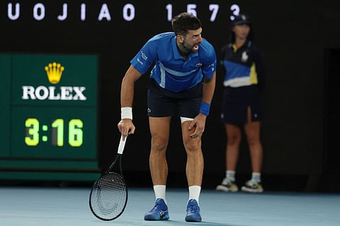 Serbia's Novak Djokovic reacts after a long rally against Spain's Carlos Alcaraz during their men's singles quarter-final match on day ten of the Australian Open tennis tournament in Melbourne.
