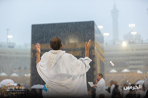 A pilgrim prays amid heavy rains in the Grand Mosque in Mecca.