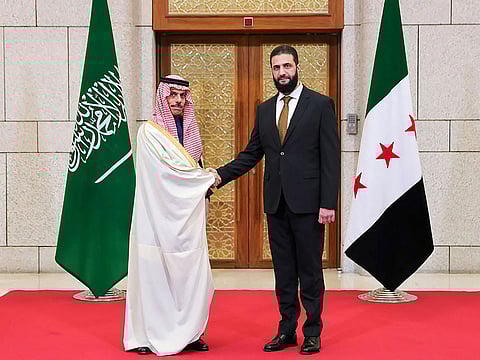 Syria's new leader, Ahmed Al Sharaa (R), welcoming Saudi Arabia's Foreign Minister Faisal bin Farhan in Damascus.