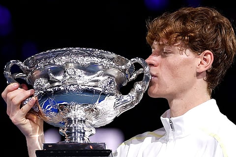 Italy's Jannik Sinner celebrates with the Norman Brookes Challenge Cup trophy after defeating Germany's Alexander Zverev during their men's singles final match on day fifteen of the Australian Open tennis tournament in Melbourne on Sunday.