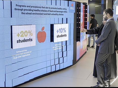 A visitor being briefed about the Masar project of MoHAP at Arab Health 2025 in Dubai