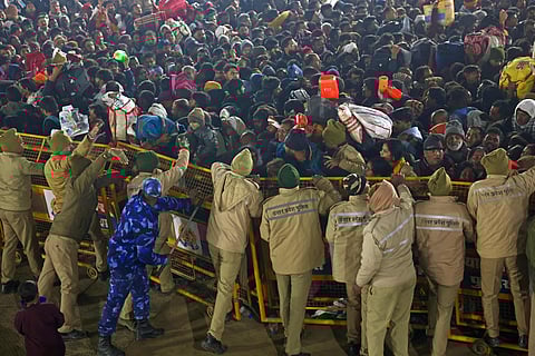Security personnel try to control the pilgrims near the site of a stampede amid the ongoing Maha Kumbh Mela festival in Prayagraj.