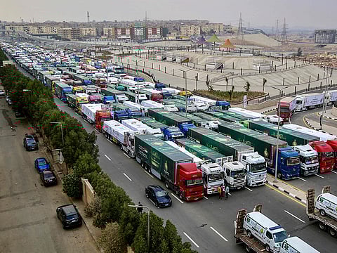 Trucks that are part of a humanitarian aid convoy carrying shipments to Palestinians in the Gaza Strip wait for the convoy to start moving in the Asmarat district in Al Muqattam on the southern outskirts of Cairo on January 26, 2025.