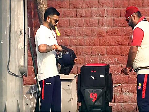 Virat Kohli talks to Delhi Ranji Trophy coach Sarandeep Singh during a practice session on the eve of the Ranji Trophy match between Delhi and Railways, at Arun Jaitely International Cricket Stadium, in New Delhi on Wednesday.