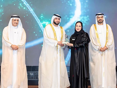 Sheikh Rashid bin Hamdan Al Maktoum presents the award to Dr Fatheya Fardallah Al Awadi in the presence of Humaid Mohammed Al Qatami (L) and Dr Khalifa Al Suwaidi in Dubai on Thursday