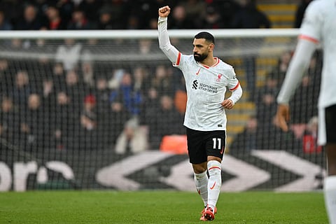 Liverpool's Egyptian striker #11 Mohamed Salah celebrates after scoring the opening goal from the penalty spot during the English Premier League football match between Bournemouth and Liverpool at the Vitality Stadium in Bournemouth, southern England on February 1, 2025.