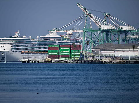 Cargo shipping containers sit stacked at an Evergreen container terminal across from the Royal Caribbean Navigator of the Seas cruise ship at the Port of Los Angeles in Los Angeles, California on February 3, 2025.