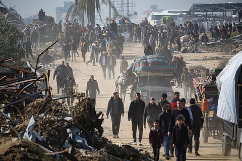 Displaced Palestinians walk towards Gaza City as they cross the Netzarim corridor from the southern Gaza Strip on January 27, 2025.