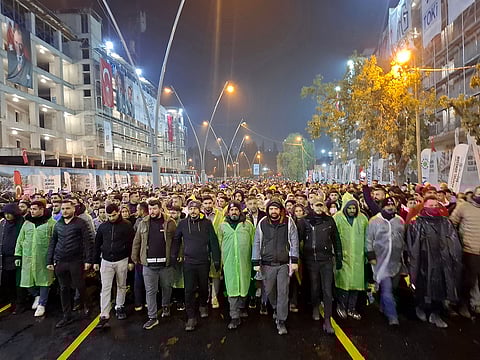This handout photograph taken and released by Turkish news agency DHA (Demiroren News Agency) in Antakya on February 6, 2025 shows mourners taking part in a vigil to mark the second anniversary of the earthquake.
