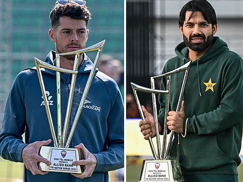 New Zealand captain Mitchell Santner and Pakistan captain Mohammad Rizwan poses with the Tri-Nation series trophy at the Gaddafi Stadium in Lahore.