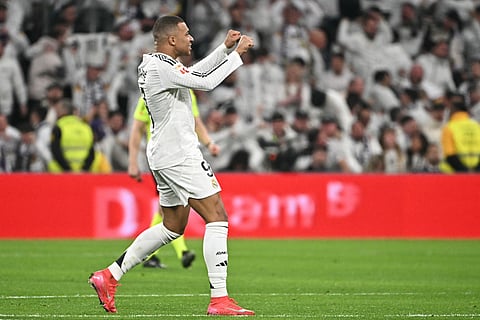 Real Madrid's French forward #09 Kylian Mbappe celebrates scoring their first goal during the Spanish league football match between Real Madrid CF and Club Atletico de Madrid at Santiago Bernabeu Stadium in Madrid on February 8.
