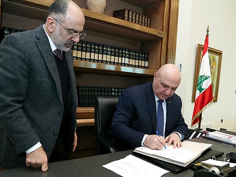 This handout picture released by the Lebanese presidency shows President Joseph Aoun (C) signing a decree at the presidential palace in Baabda, east of Beirut on February 8, 2025.