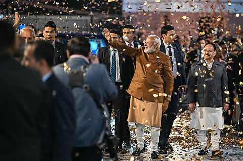 India's Prime Minister Narendra Modi (C) waves to supporters as he arrives at the Bharatiya Janata Party (BJP) headquarters to celebrate the party's win in the Delhi legislative assembly election in New Delhi on February 8, 2025.