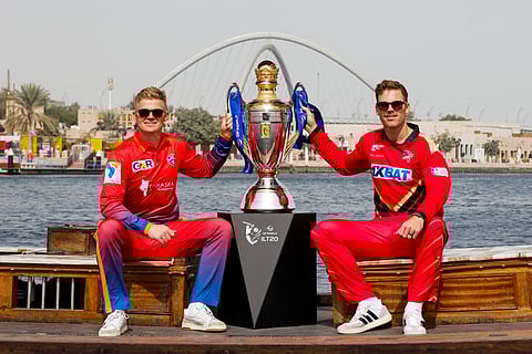 On the eve of the DP World ILT20 Season 3 final, Dubai Capitals' skipper Sam Billings (left) and Lockie Ferguson of Desert Vipers (right) sit on a traditional Abra, signifying the history and heritage of the UAE, with DP World ILT20 trophy at the Dubai Creek on Saturday.