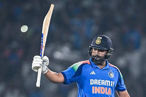 India's captain Rohit Sharma celebrates after scoring a century (100 runs) during the second one-day international (ODI) cricket match between India and England at the Barabati Stadium in Cuttack on February 9, 2025.