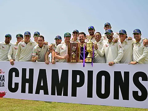 Australia's players pose with the trophy after their win at the end of the second Test match against Sri Lanka at the Galle International Cricket Stadium in Galle on February 9, 2025.