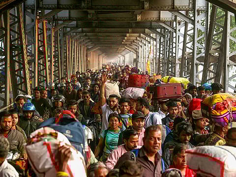 Hindu pilgrims walk along the old Yamuna bridge, during the Maha Kumbh Mela festival in Prayagraj on January 29, 2025.