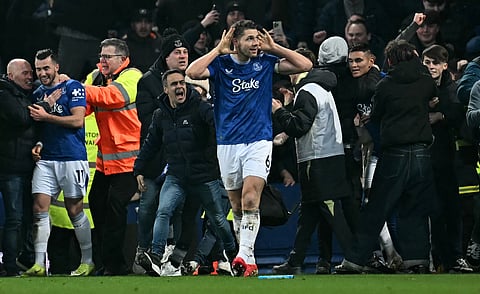 James Tarkowski (C) is mobbed by fans as he celebrates scoring the team's second goal