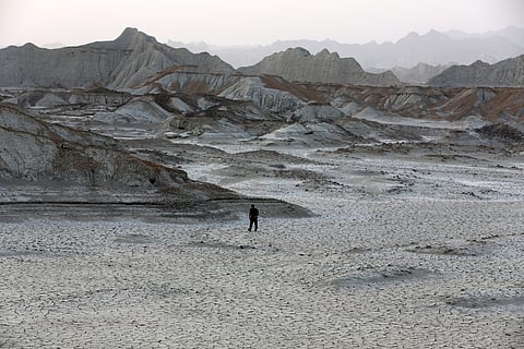 A man walks at the "Mars Mountains" site near Chabahar in Iran's southern Makran region, in the Sistan-Baluchistan province, on May 12, 2015.