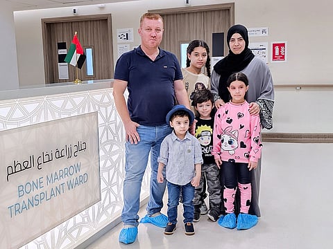 Little Mahmoud (front) leaves hospital with his family.