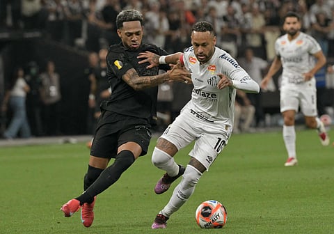 Santos' forward Neymar and Corinthians' Venezuelan midfielder Jose Martinez fight for the ball during the Campeonato Paulista A1 football match at Arena Corinthians in Sao Paulo on February 12.