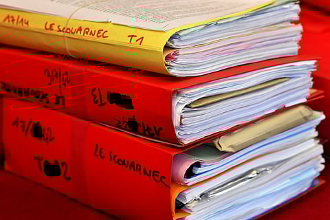 Files are displayed in the courtroom during the opening day of French surgeon Joel Le Scouarnec' s trial for the rape and sexual abuse of four child at the courthouse in Saintes, western France, on March 13, 2020.