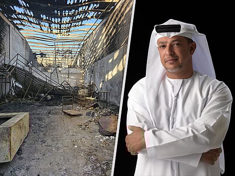 Jalal Luqman, right, and what the fire left of his works in the warehouse that served as his studio in Abu Dhabi.