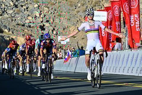 UAE Team Emirates' Slovenian rider Tadej Pogacar celebrates as he crosses the finish line at the end of the seventh stage of the UAE Tour cycling race from Hazza Bin Zayed Stadium to Jebel Hafeet in the UAE on February 23.
