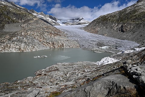 This photograph shows the Rhone Glacier and its glacial lake, formed by the melting of the glacier, above Gletsch, in the Swiss Alps on September 30, 2024.