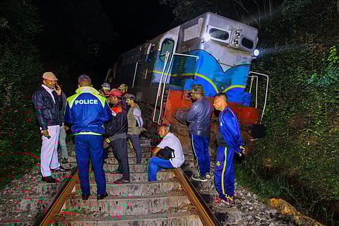 Police and railway personnel examine a derailed train at Habarana in eastern Sri Lanka on February 20, 2025, which killed six elephants.