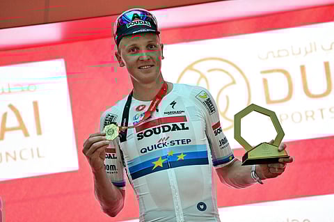 Team Soudal Quick-Step Belgian rider Tim Merlier celebrates on the podium after winning the fifth stage of the UAE Tour cycling race between the American University and the Hamdan bin Mohammed Smart University in Dubai on February 21, 2025.