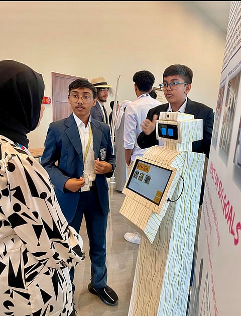 Fazin Ahmed, right, and Emil C Aneesh, demonstrate the Elli robot at the Emirates Aviation University’s 3rd Al and Data Science Competition held in Dubai. (Photo: null)