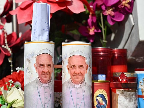 A hand written message is placed in a candle of Pope Francis outside the Gemelli hospital where Pope Francis is hospitalized in Rome, on February 22, 2025.