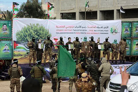 Hamas militants parade newly-released Israeli hostages as part of the seventh hostage-prisoner release on February 22, 2025.