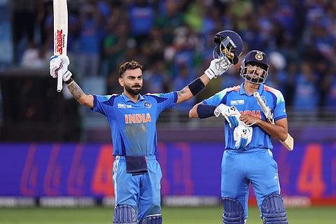 Indian batsman Virat Kohli celebrates his century and India’s win over Pakistan with Axar Patel in the Champions Trophy match at Dubai International Stadium on Sunday.